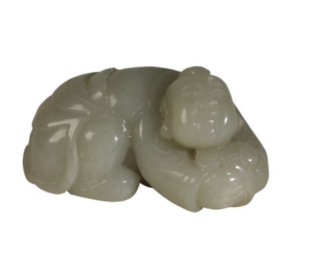 CELADON JADE FIGURE OF A BOY, 20TH CENTURY modelled hunched over holding a lingzhu fungus stem, Length: 7.5cm  