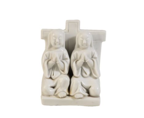 BLANC-DE-CHINE GROUP, KANGXI PERIOD modelled as two monks, each resting on one knee in prayer, Height: 10cm  