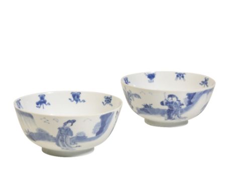 PAIR OF BLUE AND WHITE BOWLS, KANGXI PERIOD each painted in tones of underglaze blue with elegant ladies within rocky outcrop