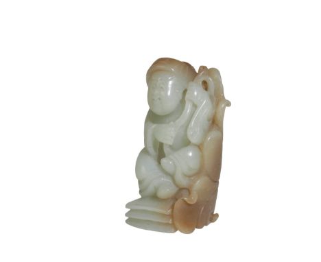 CARVED JADE 'BOY AND LOTUS' GROUP, QING DYNASTY finely carved as boy seated on an open book with a large lotus pod over his s