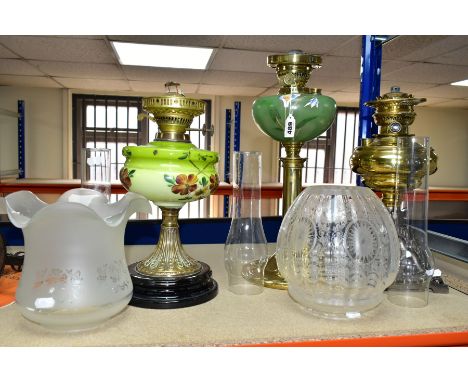 THREE OIL LAMPS, two with painted opaque glass reservoirs, the tallest measuring approximately 43cm having a brass column and
