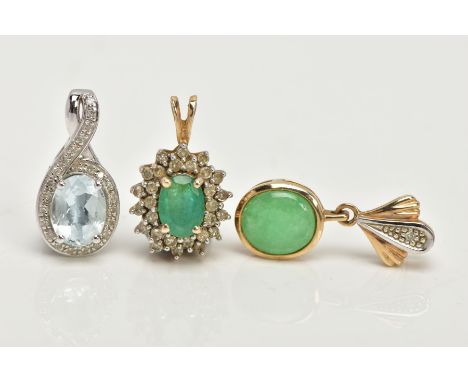 TWO YELLOW METAL PENDANTS AND A WHITE METAL PENDANT, the first an oval cut emerald set with a cluster of round brilliant cut 