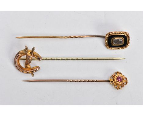 THREE EARLY 20TH CENTURY GOLD STICK PINS, the first a Etruscan style set with circular cut ruby in a star setting, stamped 15