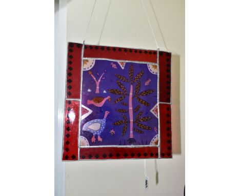 A CONTEMPORARY STAINED GLASS PANEL OF BIRDS AND TREES, leaded red glass border, fitted with hanging loops, height 30.8cm x wi
