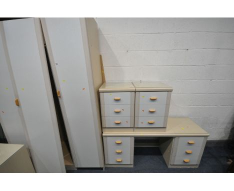 A CREAM FIVE PIECE BEDROOM SUITE, comprising a three door wardrobe, a desk with six drawers, a pair of three drawer bedside c