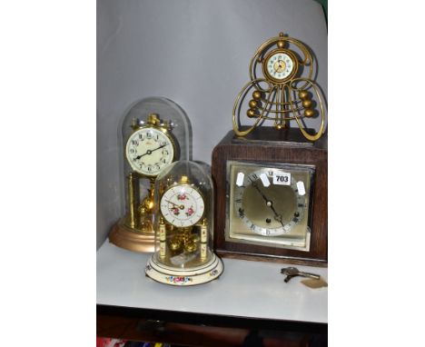 FOUR CLOCKS, comprising an art nouveau style brass cased Ansonia mantel clock, the enamel dial set within an open sinuous fra