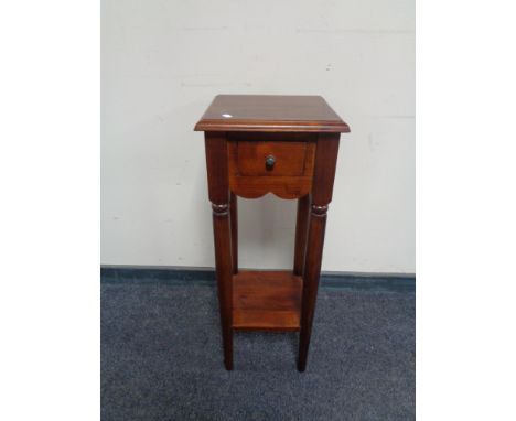 An Indonesian hardwood plant stand fitted to drawer with under shelf.  