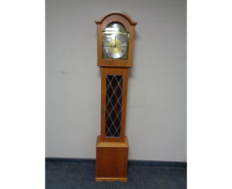 A Tempus Fugit longcase clock with pendulum and weights. 