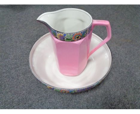 An antique English pottery pink floral wash jug and basin 