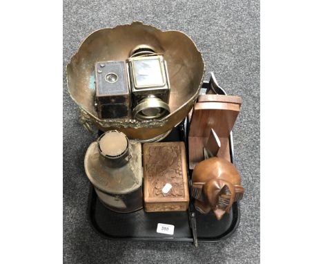A tray containing carved wooden elephant, wooden trinket box and bookends, a starboard ship's lamp, a copper plated lion mask