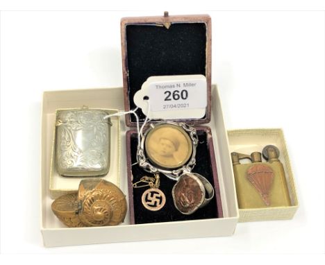 A small group of collectibles to include a silver plated vesta, a brass lighter with enamel decoration and figure of a parach