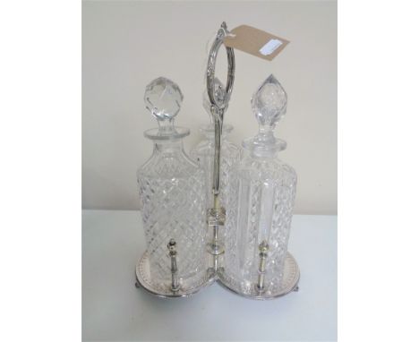 A 20th century plated three way decanter stand, three cut glass decanters with stoppers 