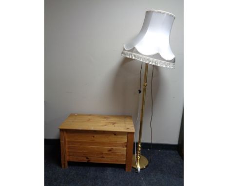 A brass standard lamp with shade together with a pine slatted blanket box. 
