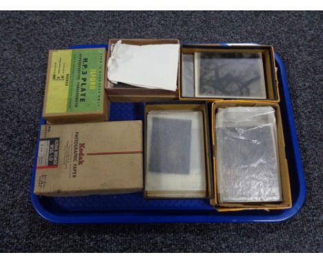 A tray containing vintage Ilford and Kodak photographic plates.  