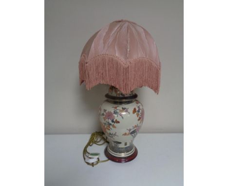 A floral pottery table lamp with shade.  