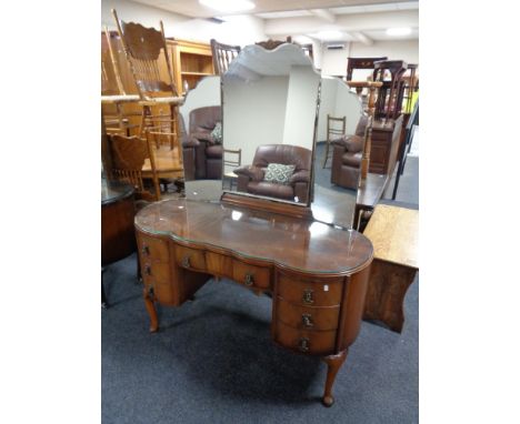 A 20th century Queen Anne kneehole dressing table fitted with seven drawers, with triple mirror.   