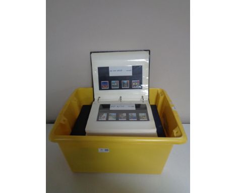 A box containing albums of stamps and first day covers. 