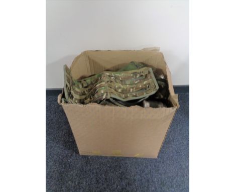 A box containing a quantity of army surplus items.  
