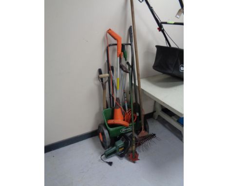 A quantity of assorted gardening tools together with an electric strimmer and a Black &amp; Decker hedge trimmer 