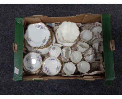 A tray containing a 28 piece gilt rimmed floral patterned china tea service. 