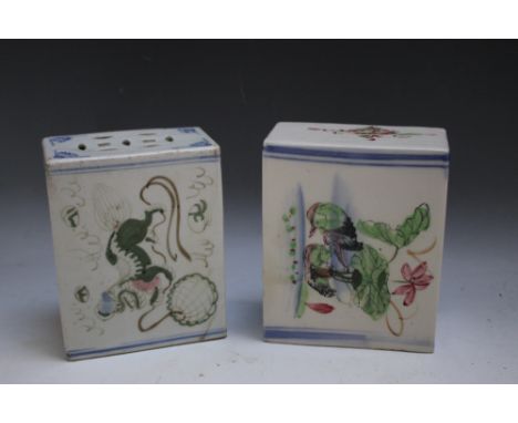TWO ORIENTAL CERAMIC PILLOWS, of typical form and naively decorated - one with ducks, one with a dog of Foe playing with a ba