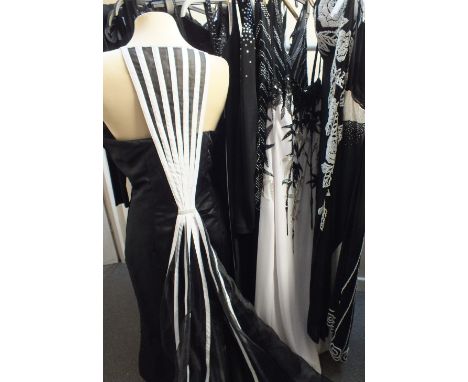 A SELECTION OF LADIES EVENING WEAR, comprising mainly full length black / white dresses, most having bead or sequin embellish