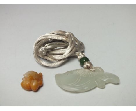A CARVED CELADON AND BROWN JADE MINIATURE PENDANT, finely carved in the form of a toad seated upon a double fruiting gourd, L