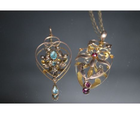 TWO 9CT GOLD EDWARDIAN TYPE PENDANTS, one set with two small pink ruby type stones, the other with blue topaz and seed pearls