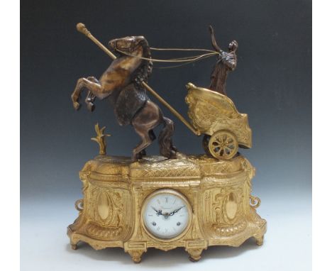 AM IMPRESSIVE BRASS FIGURAL MANTLE CLOCK, in the form of Boudica on a chariot with two rearing horses, made by Imperial, with