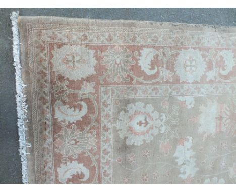 AN EASTERN 20TH CENTURY WOOLLEN RUG / CARPET, light brown floral pattern throughout, 284 x 212 cm