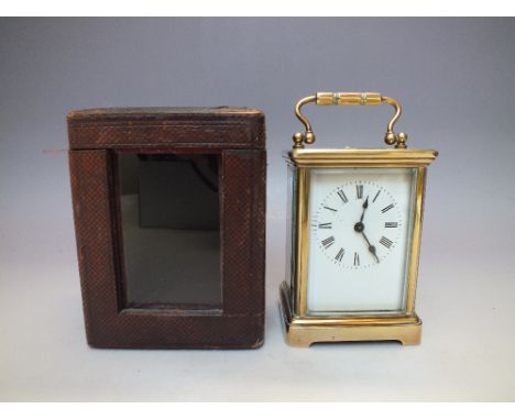 A VINTAGE BRASS CASED CARRIAGE CLOCK IN FITTED CASE, the brass case with five glass panels having visible escapement to top p