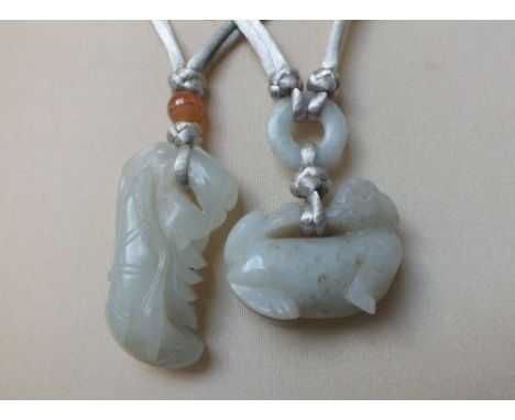 TWO JADE FIGURAL PENDANTS IN THE FORM OF MYTHICAL BEASTS, finely carved in shallow relief, one depicting a Dog of Fo, the oth