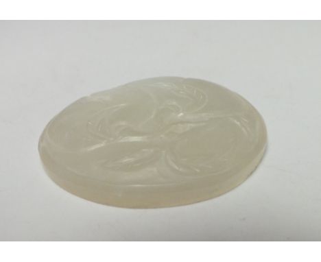 A CHINESE CELADON JADE PLAQUE, finely carved detail depicting fruit and foliage, 5.1 x 4.8 cm