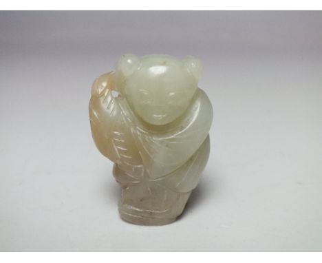 A CHINESE CELADON JADE FIGURE OF A STANDING BOY,  finely carved detail, the boy bearing a vase of flowers, H 5.1 cm