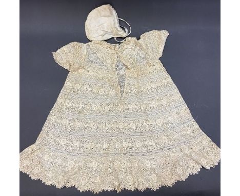 An unbleached machine bobbin lace baby dress, an unbleached lace reticule, a satin and lace baby's cap and a fine cotton baby