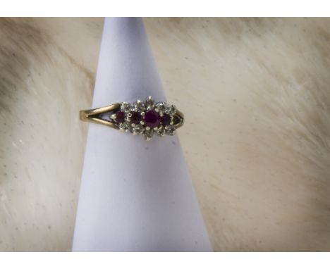 A 1970s 9ct gold ruby and diamond cluster style ring, lacking a brilliant cut, 2.4g and size L 