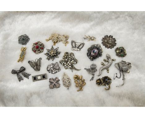 A collection of costume jewels, predominantly brooches, some being in silver, along a Jacobite Celtic themed pendant and more