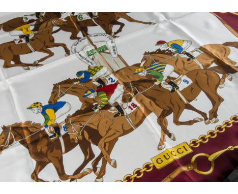 A Gucci silk scarf, with race horse and jockey designs, boxed (2) box is a bit tatty