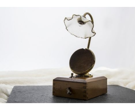 An early 20th century pocket watch stand with light, the wooden base to support a battery with brass watch holder below swan 