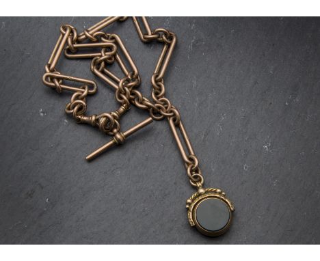 A Victorian 9ct gold double Albert watch chain, having long and circular links, supporting a spinning hardstone seal, 33.5gso