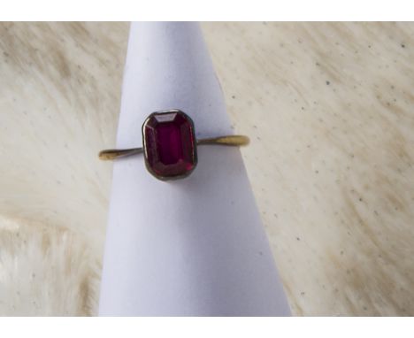 An Edwardian 18ct gold and ruby ring, the octagonal synthetic red stone in basket mount, shank marked 18ct, with a vintage bo