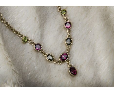 A modern 9ct gold and tourmaline fringe necklace, the lower section with green and pink stones and drop on oval link chain, 2