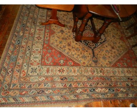 A Caucasian madder ground carpet, having three pole medallion to centre, on zoomorphic and geometric ground,m multi-bordered 