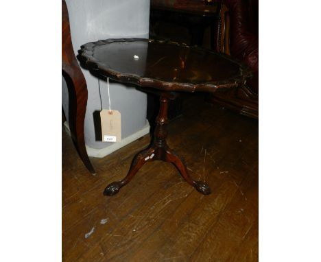 A 19th century mahogany pie-crust top tilt-top table, raised on three ball and claw tripod legs, and having a birdcage mechan
