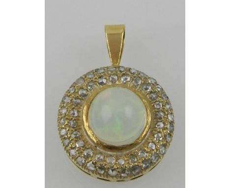 A yellow metal, opal, and diamond set circular pendant. 