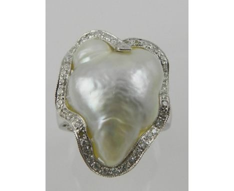 An unusual 18 carat white gold, diamond, and South Sea pearl cocktail ring, the central pearl of irregular heart-shaped form,