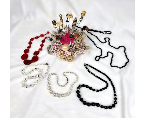 A selection of vintage hat pins, brooches, black mourning style necklaces etc.