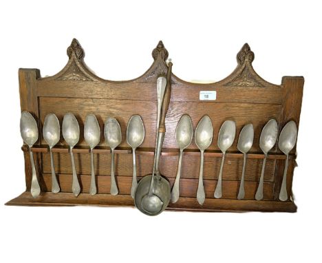 A collection of antique pewter spoons (12) some with monogram stamps etc and a pewter ladle on oak shelf.