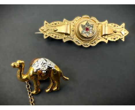 A 9ct hallmarked gold signet ring; a ruby set bar brooch stamped 9ct, 4.5gm; a brooch set with an amber coloured stone; a cam