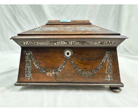 An early 19th century rosewood sarcophagus tea caddy with mother of pearl inlay and fitted interior.